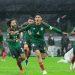 Group of soccer players in green uniforms celebrate a goal on a rainy pitch arms outstretched and smiles wide   Informe Regio