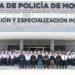 Group photo of police academy recruits and instructors standing in front of a training center with signs reading Formación y Especialización Policial above the entrance   Informe Regio
