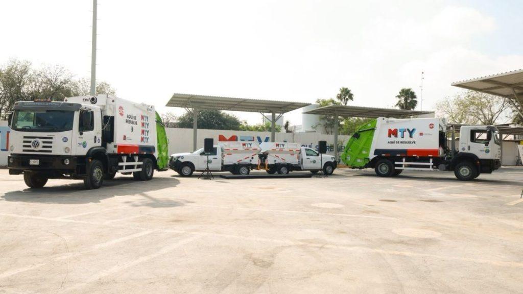 Line of white waste collection trucks with MTY logos parked in an open concrete lot under a sunny sky   Informe Regio