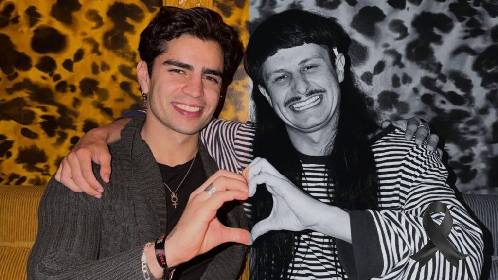Two men smile and form a heart with their hands as they sit together one with a striped shirt and long hair the other in a dark jacket with a patterned orange background and a black memorial ribbon in the corner   Informe Regio