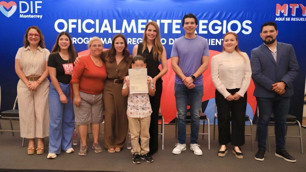 Nine people pose on stage at a DIF Monterrey event a child in front holds a certificate   Informe Regio