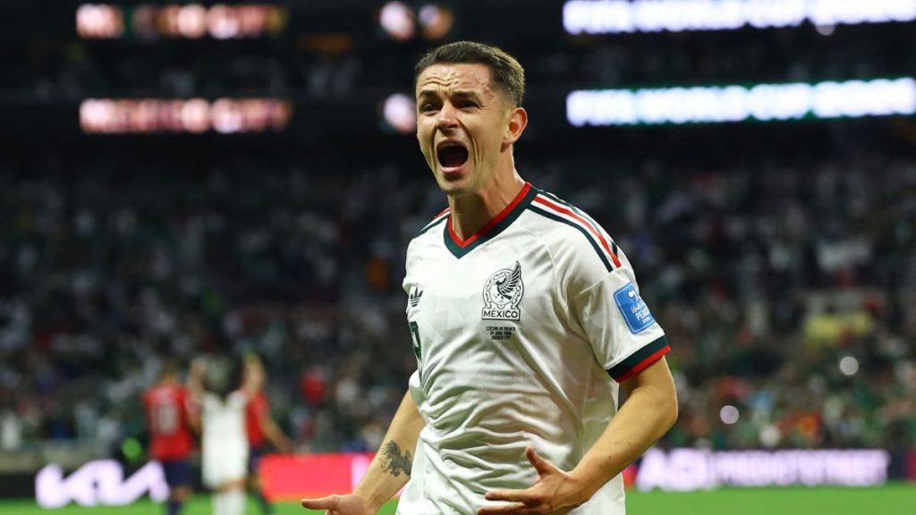 Soccer player in a white Mexico jersey celebrates with mouth open foreground in a packed stadium   Informe Regio