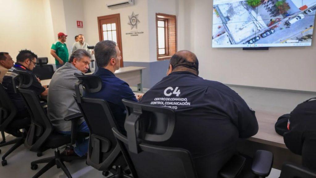 Group of officials seated in a command center watching a large surveillance screen show a street scene   Informe Regio