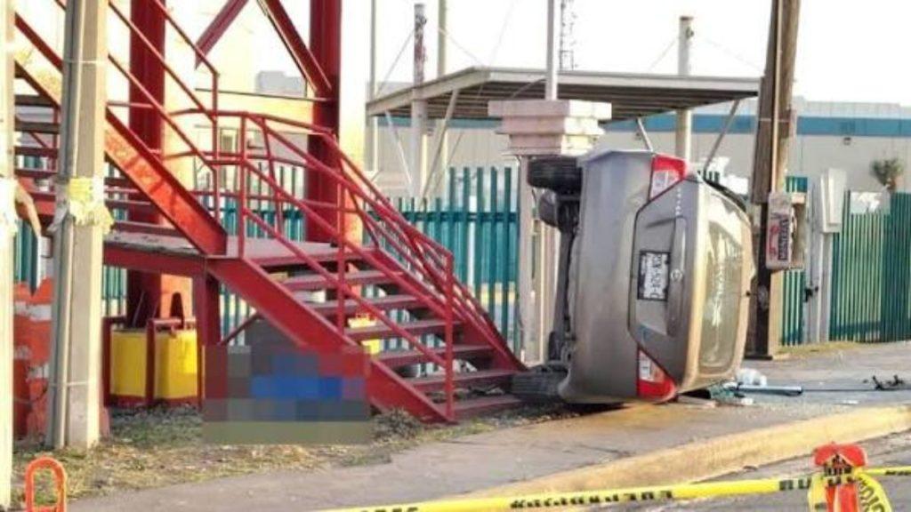 Silver SUV lying on its side next to a red metal staircase in an industrial area with yellow caution tape on the ground   Informe Regio