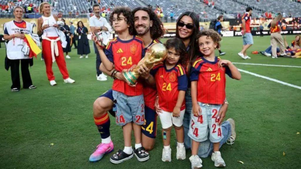Family of five on a soccer field posing with a large trophy after the match all wearing red Spain jerseys   Informe Regio
