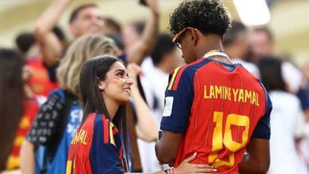 Two soccer fans in red and blue jerseys smile at each other in a crowded stadium jersey reads Lamin Yamal number 10 on back   Informe Regio