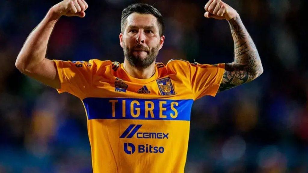 Liga-mx-andre-pierre-gignac - Informe Regio Soccer player in a yellow Tigres jersey with blue stripe celebrates fists raised in victory Informe Regio