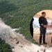 Rutas-alternas-liberar-trafico-monterrey - Informe Regio Aerial view of a forested hillside with a dirt road under construction inset shows three men in a briefing under a tent at the site Informe Regio