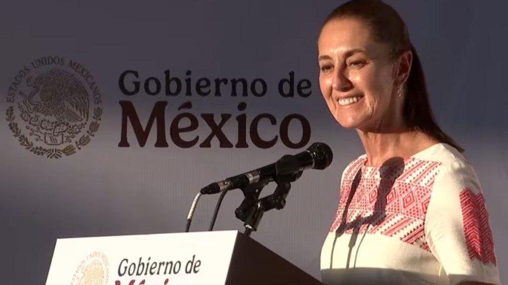 Woman smiling and speaking at a podium with microphones backdrop shows Gobierno de México and official seal   Informe Regio