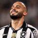 Brazilian footballer in black and white striped jersey smiling after a match with Club Botafogo crest visible on chest and sweat on neck move   Informe Regio
