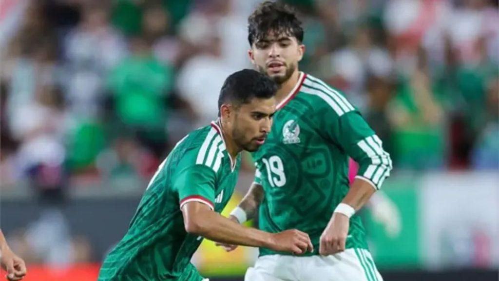 Two male soccer players in green jerseys sprint together on the field during a match celebrating or contesting play   Informe Regio