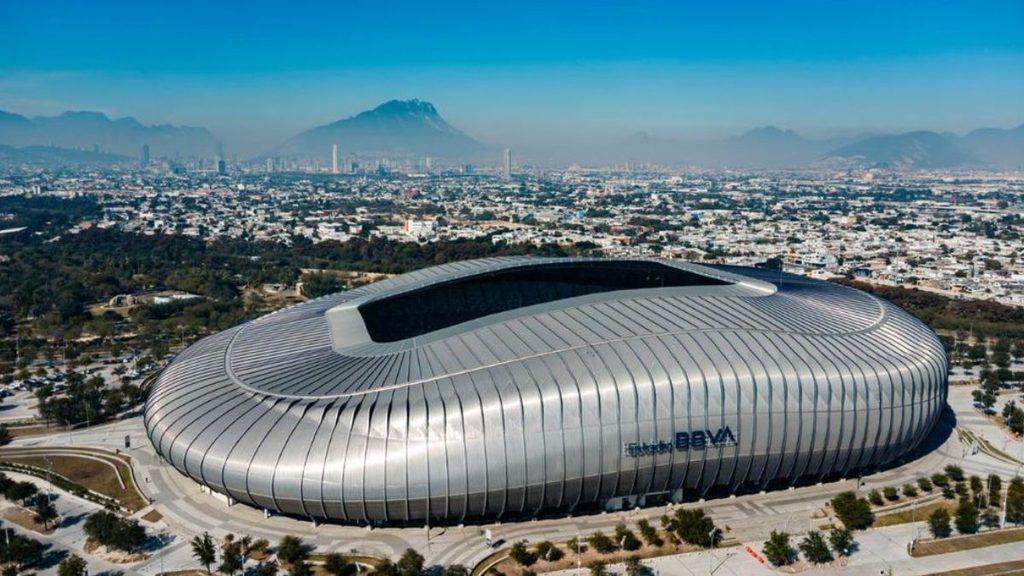 Estadio BBVA a large silver oval stadium with a ribbed exterior in a sprawling cityscape with distant mountains on the horizon   Informe Regio