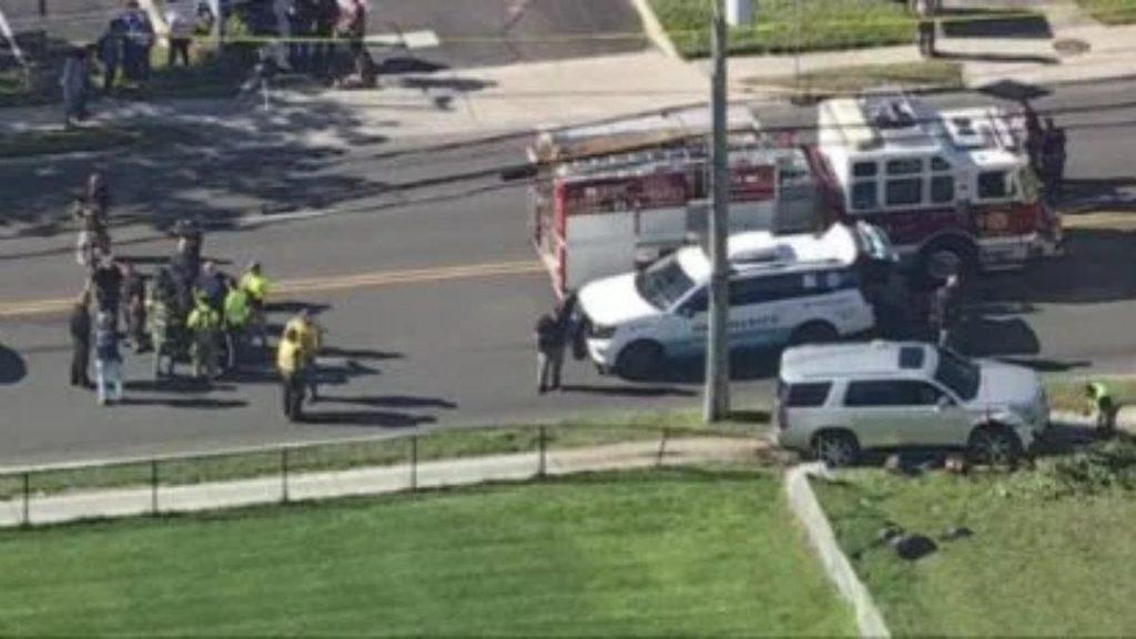 Emergency responders and bystanders at a street crash with an ambulance and police SUV on scene   Informe Regio