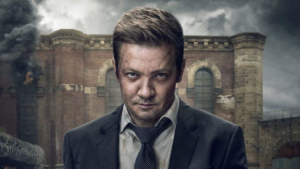 Informe-regio-se-despide-jeremy-renner-serie-mayorjpg - Informe Regio Man in a dark suit and polka dot tie stands in front of a ruined brick building with smoke in the background conveying a gritty postapocalyptic mood Informe Regio
